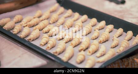 Bagel fatti in casa su una teglia da forno. Panetteria preparata per cucinare. Concetto di Natale. Colorazione vintage Foto Stock