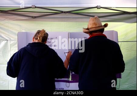 Farmer Darrell Peirpoint votes next to a local resident in the remote voting station in the western New South Wales outback town of Enngonia, Australia, June 22, 2016.    REUTERS/David Gray SEARCH 'VOTE OUTBACK' FOR THIS STORY. SEARCH 'THE WIDER IMAGE' FOR ALL STORIES.