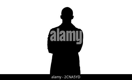 Silhouette serio medico arabo maturo maschio con braccia incrociate. Foto Stock