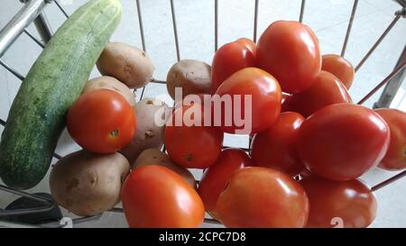 patate e cetrioli biologici isolati nel carrello o nel cestino con fuoco selettivo. Foto Stock