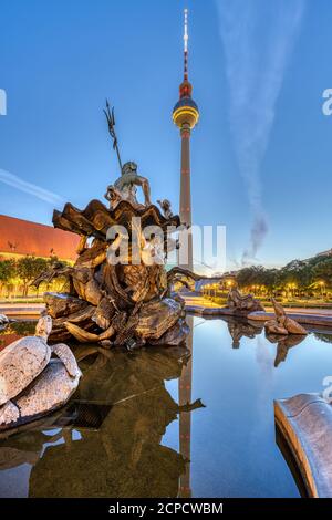 La Torre della Televisione e la fontana del Nettuno ad Alexanderplatz in Berlino all'alba Foto Stock