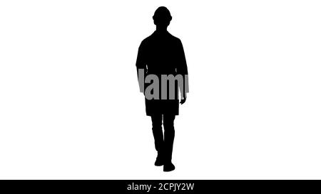 Silhouette giovane ingegnere in accappatoio e casco indossare occhiali mentre si cammina. Foto Stock