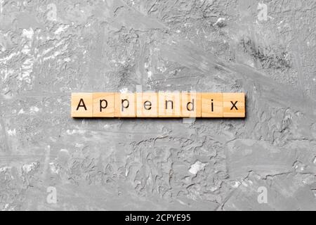 Appendice parola scritta sul blocco di legno. appendice del testo in tabella, concetto. Foto Stock