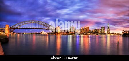 Tramonto colorato sul lungomare del CBD della città di Sydney, vicino al ponte del porto, alle Rocks e ai Barangaroo. Foto Stock