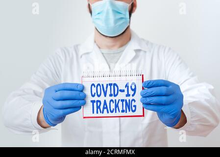 Testo scritto a mano Covid 19 Tracking. Foto concettuale processo di distinzione dei possibili soggetti infetti tecnico di laboratorio con vuoto Foto Stock