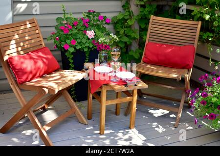 Elegante tavolo sul retro in un lussuoso giardino paesaggistico per un'atmosfera intima esperienza estiva all'aperto Foto Stock