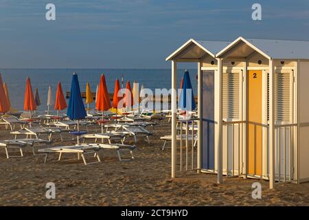 Italia Friuli Venezia Giulia, provincia di Udine, spiaggia con lettini e cabine spogliatoio Foto Stock