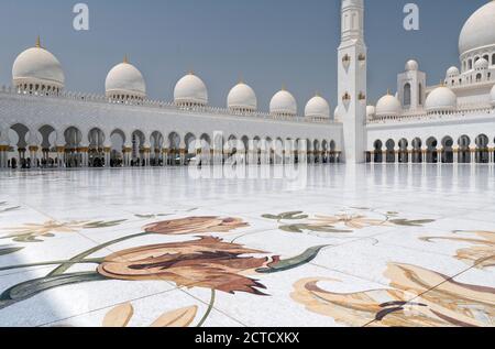 Una foto di un giorno della Grande Moschea Sheikh Zayed, cortile interno con pavimento in marmo di Abu Dhabi con cupole, archi e colonne. La moschea è stata completata nel 2007. Foto Stock