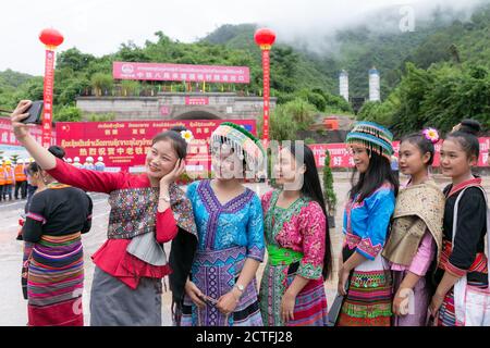 (200923) -- VIENTIANE, 23 settembre 2020 (Xinhua) -- le ragazze del Lao, nei loro abiti tradizionali festosi, posano per le foto alla cerimonia di perforazione-attraverso il tunnel di Ban Phoukeu tenuto all'uscita del tunnel a Muang Nga della provincia di Oudomxay, Laos, il 22 settembre 2020. Un'azienda di ingegneria ferroviaria cinese il martedì ha perforato attraverso il tunnel di Ban Phoukeu, l'ultimo grande tunnel lungo quasi 9,000 metri lungo la ferrovia Cina-Laos. Ha segnato un'importante pietra miliare nella costruzione della ferrovia transfrontaliera e ha gettato solide basi per il tempestivo completamento del mega progetto. (Foto di Kaikeo Foto Stock