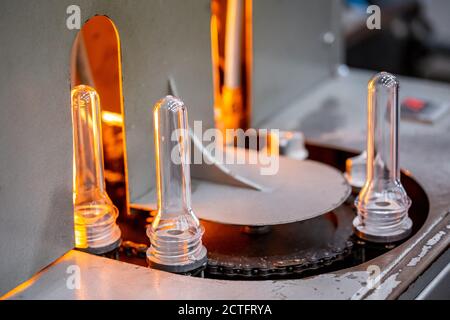 Preforme per la produzione di bottiglie in plastica PET. Fustellato per la produzione di contenitori per il latte o la birra. Apparecchiature industriali line factory Foto Stock