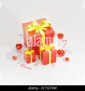 Regali di Natale su sfondo bianco, scatole regalo rosse con nastro dorato lucido, palline rosse, canna di natale e decorazione stelle. Rendering 3D. Foto Stock