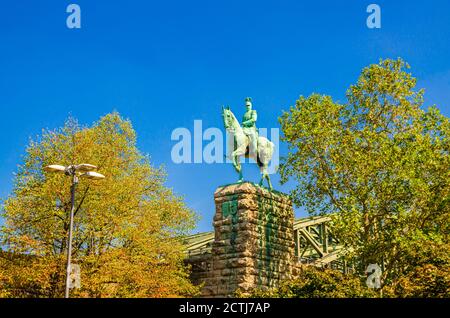 Statua equestre del Kaiser Wilhelm II monumento su piedistallo di pietra vicino al ponte Hohenzollern nel centro storico di Colonia, cielo blu chiaro sfondo in giornata di sole, Nord Reno-Westfalia, Germania Foto Stock