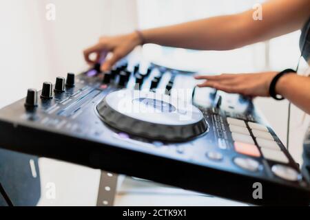 Mani di DJ femminile mixando suono in studio di registrazione Foto Stock