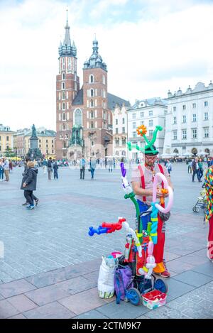 Cracovia, Polonia. 27 agosto 2018. L'artista di strada intrattiene i bambini facendo animali in mongolfiera. Un clown sulla Piazza del mercato di Cracovia, vicino a St. Mary's. Foto Stock