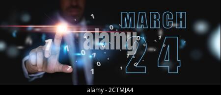 24 marzo. Giorno 24 del mese, pubblicità o calendario high-tech, l'uomo in abito preme pulsante virtuale brillante primavera mese, giorno dell'anno concetto. Foto Stock