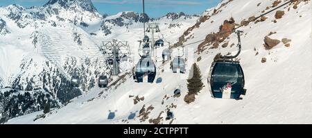 Ischgl, Austria - 10 gennaio 2020: Nuova moderna e spaziosa cabina gondola FimbaBahn contro il paesaggio montano in una lussuosa località invernale austriaca. Ampia Foto Stock