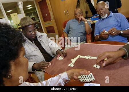 Gli anziani giocano a domino in un centro multiculturale; Bradford Foto Stock