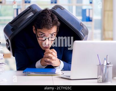 Il dipendente pensando di vacanza a causa di un eccessivo carico di lavoro Foto Stock