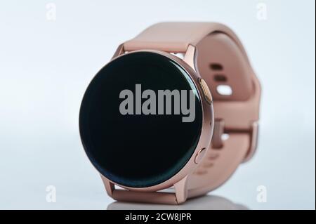 Smartwatch moderno con banda rosa isolata su sfondo bianco Foto Stock