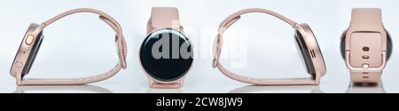 Smartwatch con braccialetto rosa vista diversa isolato su studio bianco sfondo Foto Stock