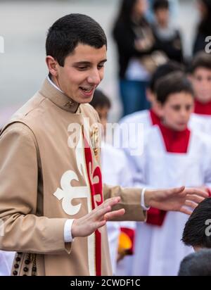 Cuenca, Ecuador - Giugno 4, 2015 - Vice parroco cattolico sacerdote partecipante parla ai giovani ragazzi prima di Corpus Cristi processione Foto Stock