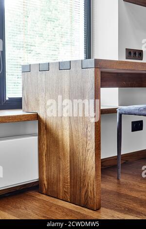 Arredamento moderno. Console in legno massello con giunzione a scatola sullo sfondo della finestra Foto Stock