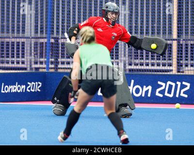One of the New Zealand women's hockey team goalies saves a shot from a team mate during a training session at the Olympic Hockey venue, the Riverbank Arena, at the Olympic Park in Stratford, east London, July 17, 2012. The London 2012 Olympic Games begin in 10 days time.  REUTERS/Andrew Winning (BRITAIN - Tags: SPORT FIELD HOCKEY OLYMPICS)