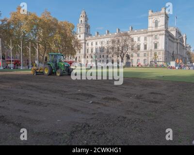 Paesaggisti visto al lavoro con macchinari pesanti e la posa di un nuovo prato sul giardino di Parliament Square. Foto Stock