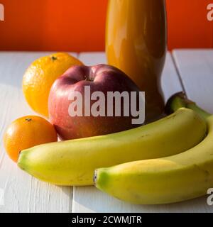 Frutta fresca e succo sul tavolo di legno Foto Stock