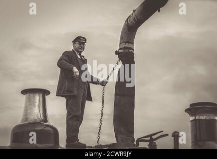 Trenino a vapore monotono che riempie di acqua la locomotiva a vapore d'epoca, ferrovia storica della Severn Valley, Kidderminster, Regno Unito. Foto Stock