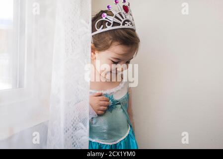 Sorridente bambina di 4 anni vestita di abito blu della principessa e corona Foto Stock