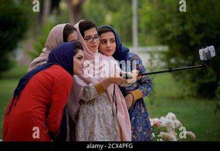 Donne iraniane moderne che prendono un selfie di gruppo, Hasht behest Palace Gardens, Isfahan, Iran Foto Stock