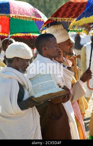 Sacerdoti etiopi che frequentano un funerale nelle loro vesti liturgiche. Lettura dalla bibbia. Axum, Tigray, Etiopia Foto Stock