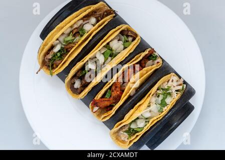 Vista dall'alto del pasto abbondante di asada carne, pollo e tacos di maiale tentano le papille gustative di mangiare l'intero pasto. Foto Stock