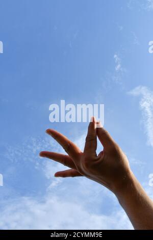 Man mano posizione, cercare di toccare il cielo Foto Stock