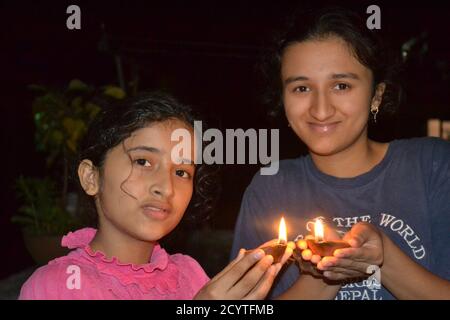 Due ragazze che tengono le lampade ad olio di deepawali. Foto Stock