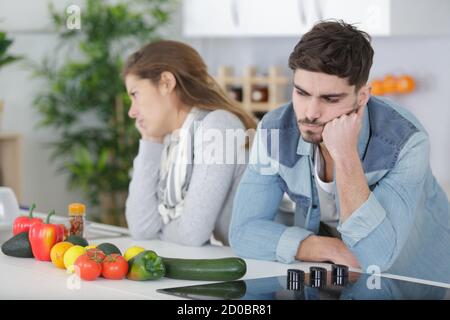 giovane coppia che si frega dopo un argomento in cucina Foto Stock