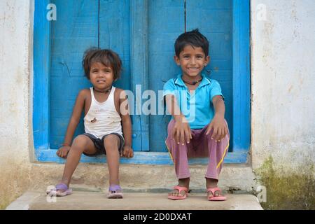 TIKAMGARH, MADHYA PRADESH, INDIA - 14 SETTEMBRE 2020: Un ragazzo e una ragazza non identificati sono seduti alla porta della loro casa. Foto Stock