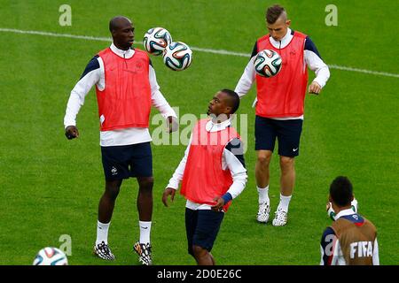 France's national soccer team player Patrice Evra (C) juggles the ball during a training session at the Beira-Rio stadium in Porto Alegre, June 14, 2014. France will play in a Group E match against Honduras on June 15.  REUTERS/Marko Djurica (BRAZIL  - Tags: SOCCER SPORT WORLD CUP)