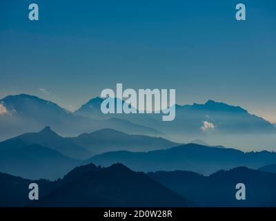 Silhouette di montagna blu, panorama alpino dal Schafberg con le Alpi Berchtesgadener, sinistra Hoher Göll, medio Watzmann, destra Hochkalter, in fr Foto Stock
