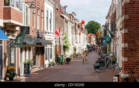 Vista sul centro storico di Gouda. Via Lange Groenendaal con numerosi negozi e tipiche case olandesi. Olanda meridionale, Paesi Bassi. Foto Stock