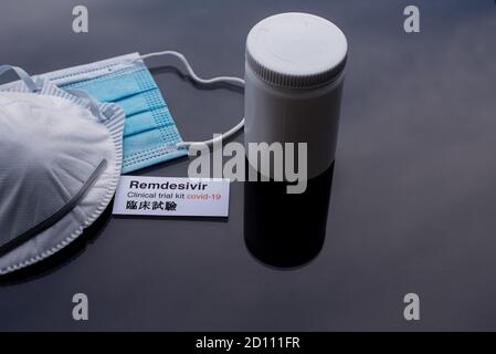 Remdesivir un farmaco sperimentale contro covid-19 e due maschere su una superficie nera, Danimarca, 4 ottobre 2020 Foto Stock