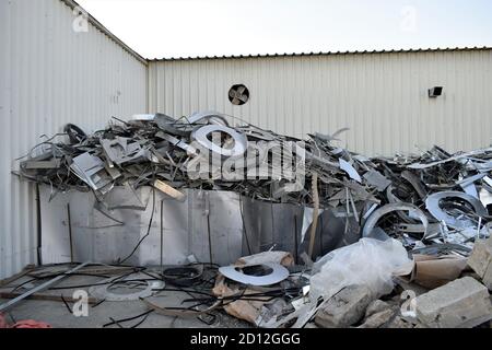 Sprechi di lamiera all'esterno della fabbrica di condotti. Serpentina in acciaio galvanizzato nella fabbrica di condotti. Rotoli confezionati di lamiera d'acciaio, bobine d'acciaio laminate a freddo. Foto Stock