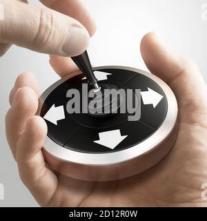 Uomo che usa un joystick concettuale per cambiare direzione. Concetto di orientamento strategico. Immagine composita tra una fotografia a mano e uno sfondo 3D. Foto Stock