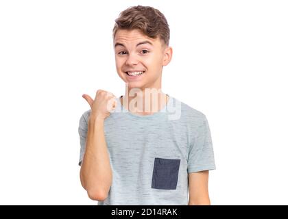 Cute teen boy che punta in su, gesturing idea o facendo il gesto numero uno. Foto Stock