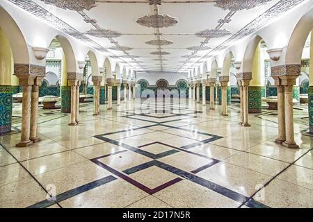 Vista panoramica simmetrica dei dettagli architettonici della sala di abluizione con fontane d'acqua in marmo nella moschea di Hassan II, Casablanca, Marocco Foto Stock