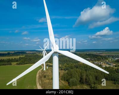Vista del drone di una turbina eolica in un giorno soleggiato. Rispetto dell'ambiente, concetto di fonti energetiche rinnovabili. Foto Stock