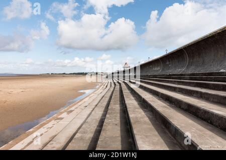 Vista generale che guarda a nord lungo le difese del mare adiacente all'Esplanade, che mostra le mura e i gradini del mare, Sedgemoor, Somerset, UK. Foto Stock