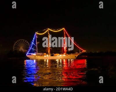 Luci colorate sui montanti sulle barche a vela che circondano sfocate dal movimento Foto Stock