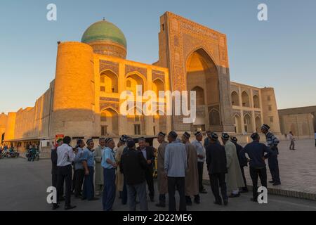 Gruppo di turisti maschili uzbeki che visitano il complesso po-i-Kalan. Bukhara, Uzbekistan, Foto Stock